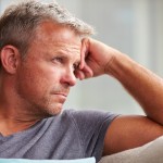 Man looking out into distant clearly suffering from some internal pain