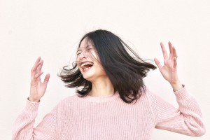 Young Woman laughing and shaking Head