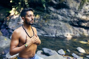 Man Meditating by the River