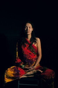 Woman Meditating in a dark room