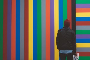 Man in front of colorful wall