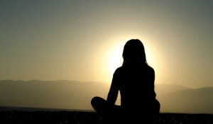 Woman Meditating at the Sun