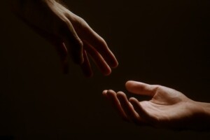 Hands Touching in the Dark
