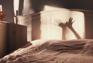 Shadow Hands on a Bed
