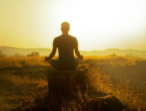 Meditating on a Log at Sunrise