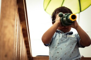 Kid Looking Through a Telescope