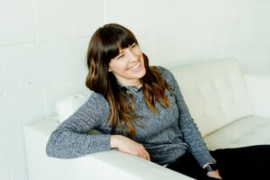 A Woman Smiling on a Couch