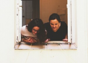 Curious Woman Looking out a Window