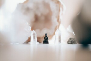 A Small Buddha on the Table with Crystals
