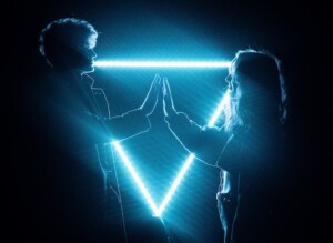 Hands Touching in Front of Bright Triangle Light