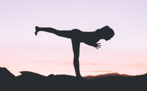 Person doing Yoga at Sunset on a Rock